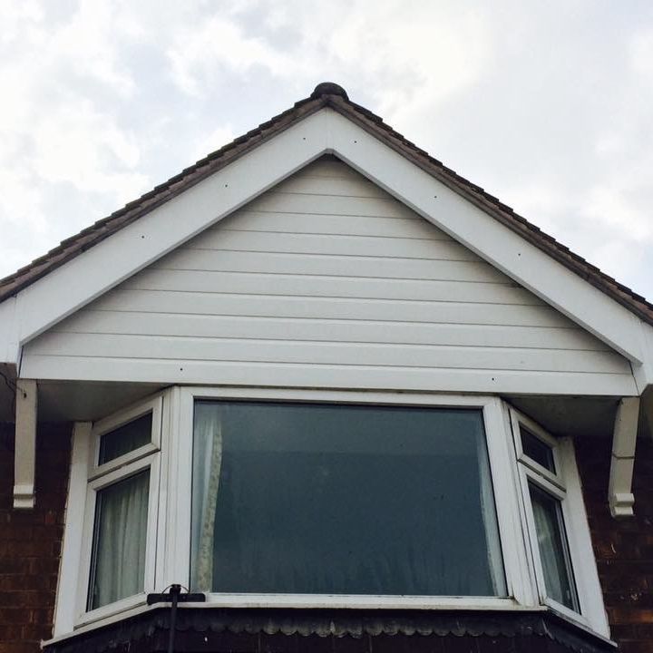 The same gable end and window looking clean and white after Ryan's Window Cleaning